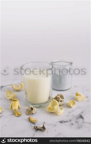 close up dry pods candle candleholder marble surface. Beautiful photo. close up dry pods candle candleholder marble surface