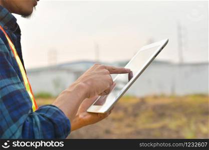 Close up Engineer Construction holding tablet checking work estate technology