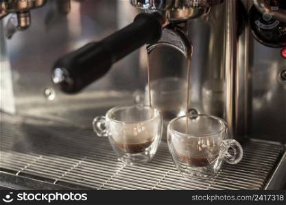 close up espresso pouring into cups