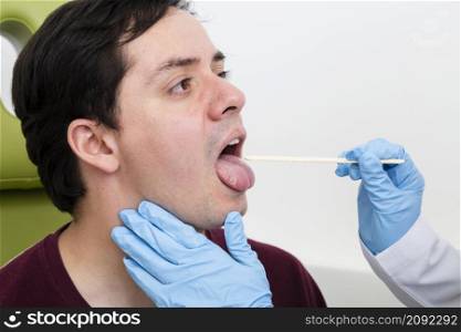close up examination with tongue depressor