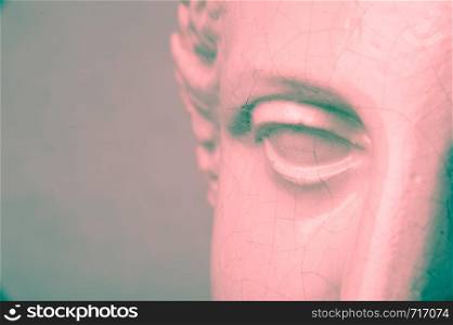 Close up face gypsum copy antique sculpture with craquelure . Red green duotone lighting effect.. Close up face gypsum copy antique sculpture with craquelure. Red green vintage filter effect .