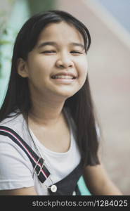 close up face of asian teenager laughing with happiness emotion