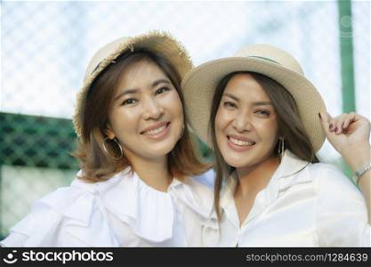 close up face of toothy smiling face asian younger woman vacation relaxing