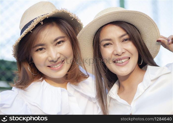 close up face of toothy smiling face asian younger woman vacation relaxing