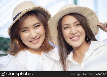 close up face of toothy smiling face asian younger woman vacation relaxing