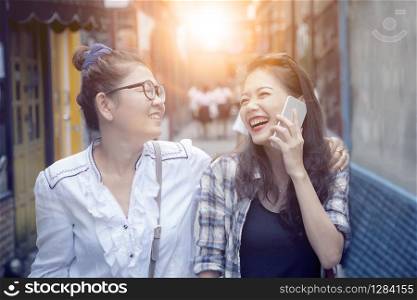 close up face of two asian woman laughing with happiness emotion in shopping street