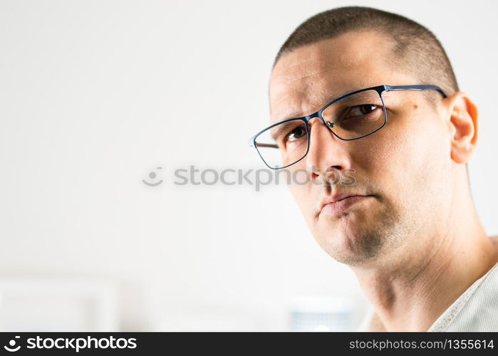 Close up face portrait head shot of adult caucasian man short hair wearing eyeglasses looking to the camera indoor front view