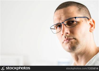 Close up face portrait head shot of adult caucasian man short hair wearing eyeglasses looking to the camera indoor front view