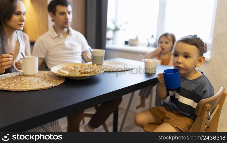close up family sitting table