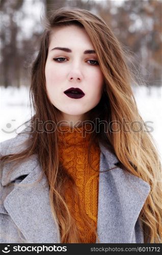 Close up fashion portrait of alluring woman model with luxury fashion make-up, dark black lips makeup, perfect skin and long ombre hair. Trends colors, marsala wine color lipstick, eyebrows, sexy hair