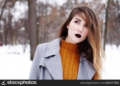 Close up fashion portrait of alluring woman model with luxury fashion make-up, dark black lips makeup, perfect skin and long ombre hair. Trends colors, marsala wine color lipstick, eyebrows, sexy hair