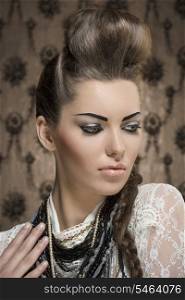 close-up fashion portrait of charming female with creative look, cute brunette hair-style and strong make-up. Wearing white lace shirt and a lot of necklaces
