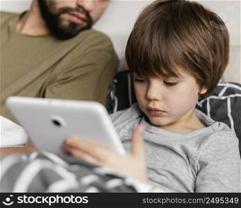 close up father kid with tablet