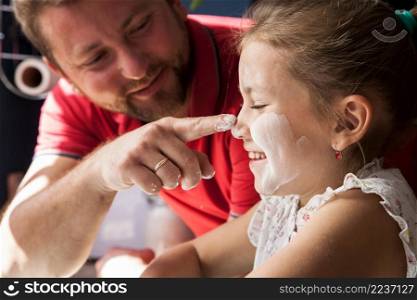 close up father touching his daughter s nose