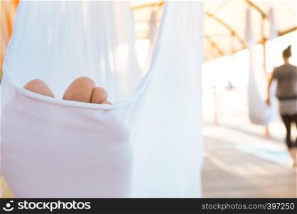 Close up feet in a hammock. Healthy and fly Yoga Concept
