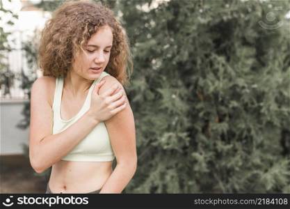 close up female athlete having pain shoulder