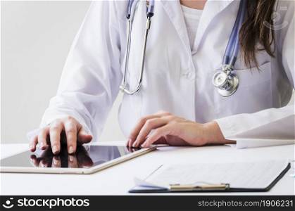 close up female doctor using digital tablet medical report desk. High resolution photo. close up female doctor using digital tablet medical report desk. High quality photo