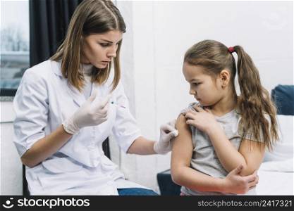 close up female doctor wearing white gloves hand giving syringe patient s arm