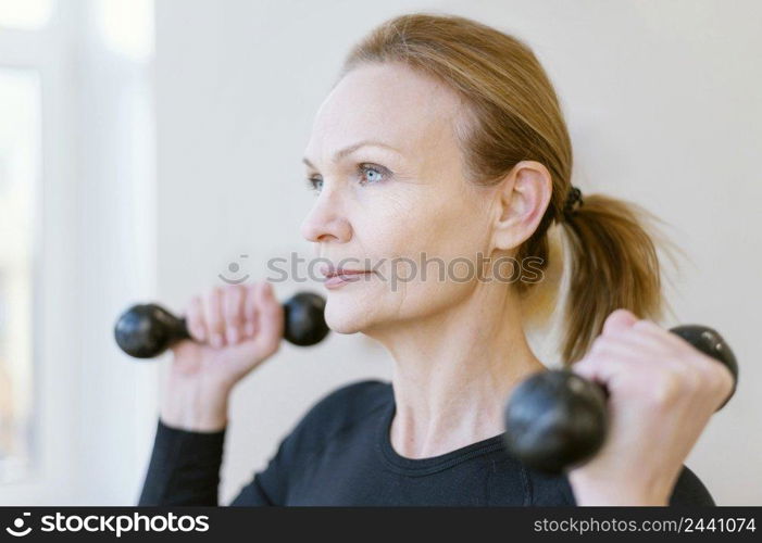 close up female holding dumbbells