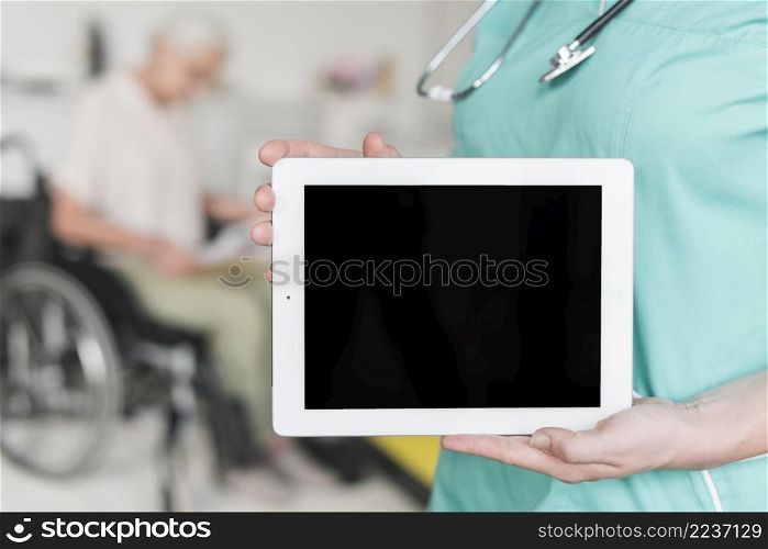 close up female nurse showing blank screen digital tablet