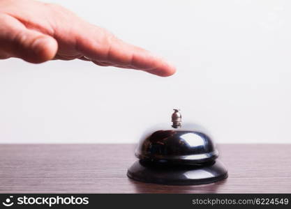 Close-up finger that presses of the service bell ring. Service bell ring