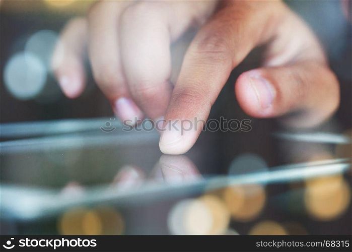close-up finger touching on communicator electronic device on night