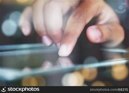 close-up finger touching on communicator electronic device on night