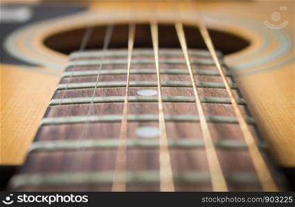 Close Up Fingerboard and Inlay of 6 String Brown Wood Acoustic Guitar