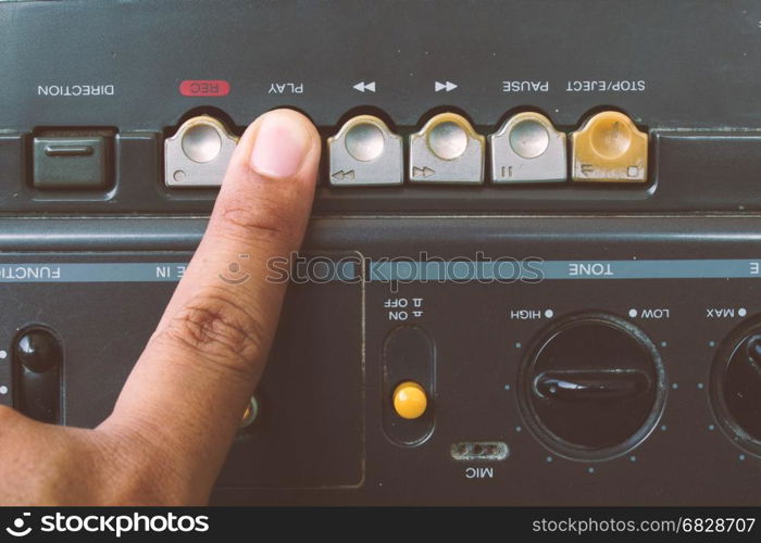 Close up fingers to play radio cassette player,Vintage style.