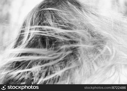 Close up flowing blond hair monochrome concept photo. Attractive woman. Side view photography with beautiful hairstyle on background. High quality picture for wallpaper, travel blog, magazine, article. Close up flowing blond hair monochrome concept photo