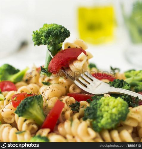 close up fork with broccoli tomato fusilli. Resolution and high quality beautiful photo. close up fork with broccoli tomato fusilli. High quality beautiful photo concept
