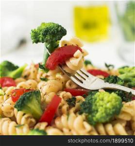 close up fork with broccoli tomato fusilli. Resolution and high quality beautiful photo. close up fork with broccoli tomato fusilli. High quality beautiful photo concept