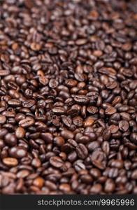Close up fresh raw organic coffee beans top view background. Macro