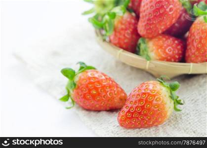 close up fresh red strawberries over sackcloth , ripe fruit