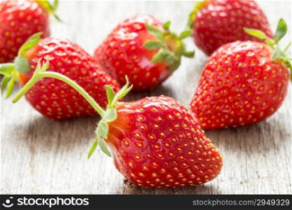 Close up fresh strawberries on wooden background