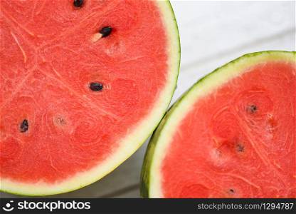 Close up fresh watermelon pieces tropical summer fruit / Sliced half watermelon on wooden background