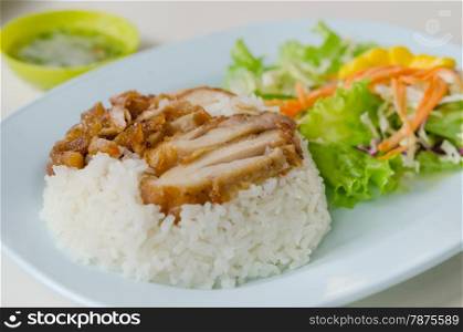 close up fried Chicken over steamed rice on plate