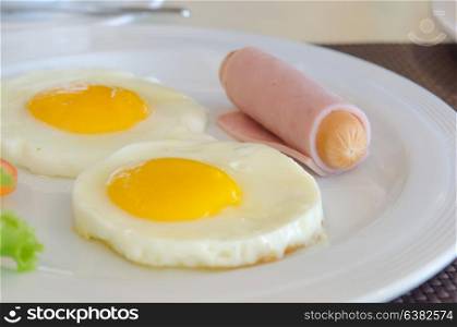 close up fried egg with ham and sausage