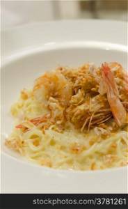 close up fried shrimp served with Spaghetti Carbonara and cheese. Spaghetti