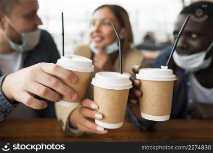 close up friends holding cups