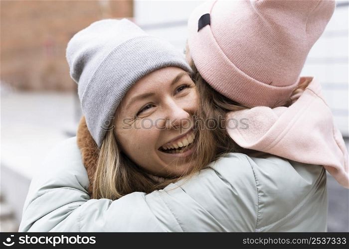 close up friends hugging outdoors