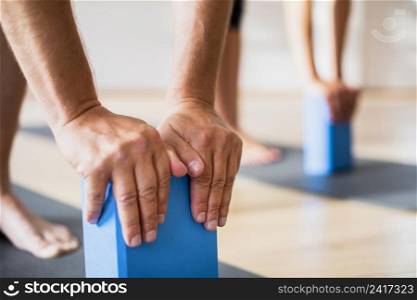 close up friends training with pilates blocks