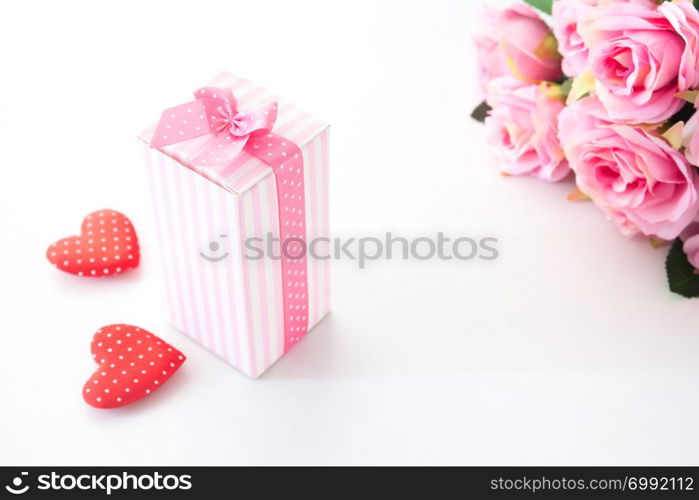 Close up gift box on white background with pink rose and heart on white background