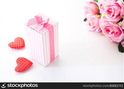 Close up gift box on white background with pink rose and heart on white background