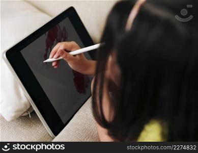 close up girl drawing her tablet with pen