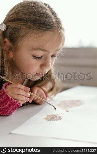 close up girl painting indoors