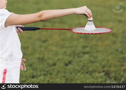 close up girl playing badminton