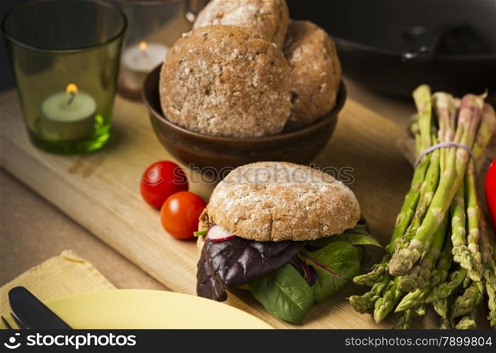 Close up Gourmet Healthy Food with Bread and Veggies on Wooden Board, Emphasizing Leafy Vegetables, Asparagus and Tomatoes