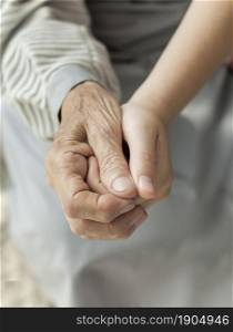 close up granddaughter holding grandmothers hand. Beautiful photo. close up granddaughter holding grandmothers hand