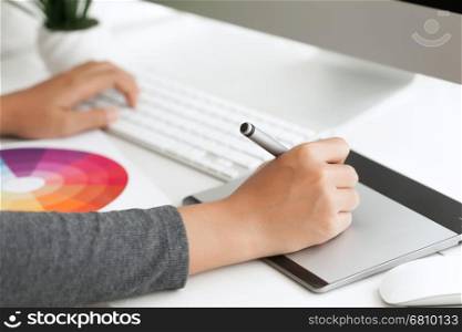 close up graphic design using digital pen tablet on desk workspace